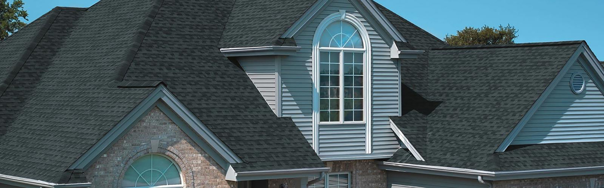 Large residential roof with black shingles